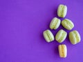 French green macarons shaped as Christmas tree on purple background. Top view