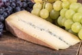 French morbier cheese with black and white grapes Royalty Free Stock Photo