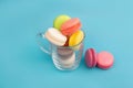 French multicolored macaroons in a transparent cup. Dessert