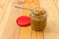 French mustard on spoon in glass jar on rustic table Royalty Free Stock Photo