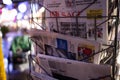 French newspapers at press kiosk with defocused city background