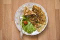 French omelet with saburani on wooden background