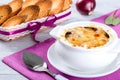 French onion gratin soup in a white pot, close-up Royalty Free Stock Photo