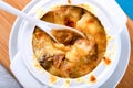 French onion gratin soup in a white pot, close-up Royalty Free Stock Photo