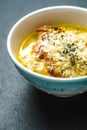 French onion soup in blue ceramic bowl side view Royalty Free Stock Photo