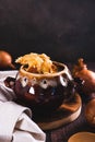 French onion soup with melted cheese and croutons in a pot on the table vertical view Royalty Free Stock Photo