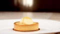 French patisserie. Still life with a delicious tartlet with lemon on a white plate