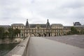 French people driving and biking with travelers walking and traffic road at front of Musee du Louvre