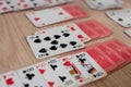 French playing cards stacked together in a solitaire. Solitaire game with cards, pastime with signs and cards with red backs and Royalty Free Stock Photo