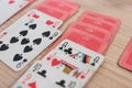 French playing cards stacked together in a solitaire. Solitaire game with cards, pastime with signs and cards with red backs and Royalty Free Stock Photo