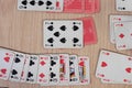 French playing cards stacked together in a solitaire. Solitaire game with cards, pastime with signs and cards with red backs and Royalty Free Stock Photo