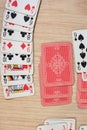 French playing cards stacked together in a solitaire. Solitaire game with cards, pastime with signs and cards with red backs and Royalty Free Stock Photo