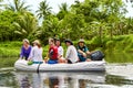 Group of travelers on an inflatable boat exploring the island Tahaa