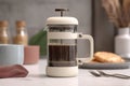 French press brewing coffee with pastries on the table in a modern kitchen setting Royalty Free Stock Photo