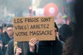 French protester showing a sign written in French saying \'Fridges are empty ! Stop your massacre\'