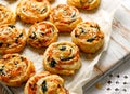 French Puff Pastry Pinwheels stuffed with salmon, cheese and spinach on on baking paper