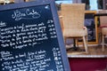 French restaurant Paris France menu board close up, tables and chairs in background Royalty Free Stock Photo