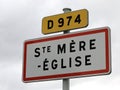 French road sign indicating the place where the paratrooper hanging from the bell tower who fell during the Normandy landings