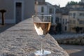 French rose dry wine from Provence in glass in sunny day with view on old streets of Arles town in sunny day