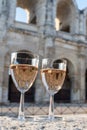 French rose dry wine from Provence in two glasses in sunny day with view on old streets of Arles town in sunny day