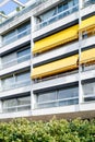 French 70`s architectural style building with yellow awnings Royalty Free Stock Photo