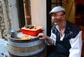 French seller invites tourists to taste sausages