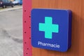 French shop pharmacie green cross sign of pharmacy on store wall building Royalty Free Stock Photo