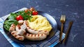 French side dish potato aligot with tomato salad Royalty Free Stock Photo