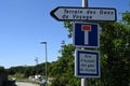 Close-up of French road signs indicating a reception area for travelers