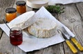 French soft cheese with a different jam on the natural wood back Royalty Free Stock Photo