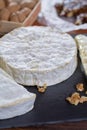 French soft cheeses - camembert, marcaire, munster, brie - delicious dessert with nuts and dried fruits Royalty Free Stock Photo