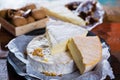 French soft cheeses - camembert, marcaire, munster, brie - delicious dessert with nuts and dried fruits Royalty Free Stock Photo