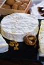 French soft cheeses - camembert, marcaire, munster, brie - delicious dessert with nuts and dried fruits Royalty Free Stock Photo