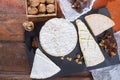 French soft cheeses - camembert, marcaire, munster, brie - delicious dessert with nuts and dried fruits