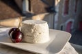 French soft white goat cheese served outdoor with fresh cherry Royalty Free Stock Photo