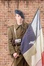 1940 french soldier with a flag, wall of red brick at the back Royalty Free Stock Photo