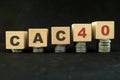 French stock market economy growth and recovery concept. CAC40 index in wooden blocks with increasing stack of coins in black back