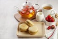 French strawberry pistachio macaron with berries tea. Afternoon tea still life