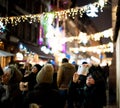 French street with large group of people woman taking photograph of Christmas Market