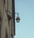 French Streetlight hanged on a building. Royalty Free Stock Photo