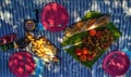 French style picnic top view on a tablecloth on green grass. Brie cheese, camembert, baguette, grapes, peaches and pate.