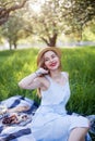 French style romantic picnic setting. Woman in cotton dress