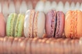 Macarons on golden paper and sunlight and shadows. Copy space. Closeup. Macro. Soft focus.