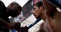 A French team muay thai boxer gets advised by the coach during a fight at the 9th World Thai Martial Arts Festival in Ayutthaya, T