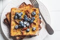 French toast with blueberries, pecan and maple syrup for breakfast on white plate Royalty Free Stock Photo