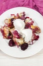 French toast casserole with berries and vanilla ice cream on white wooden background Royalty Free Stock Photo