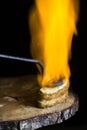French toast topped with cream and sugar and flamed with an incandescent iron in the traditional style. large flame of fire.