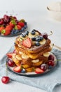 French toasts with berries and banana, brioche breakfast, white background, vertical closeup