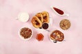 French toasts and granola on a pink table with breadcrumbs. Fried bread with milk and scrambled eggs. Top view, place for text. Royalty Free Stock Photo