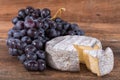French tomme cheese with black grapes Royalty Free Stock Photo